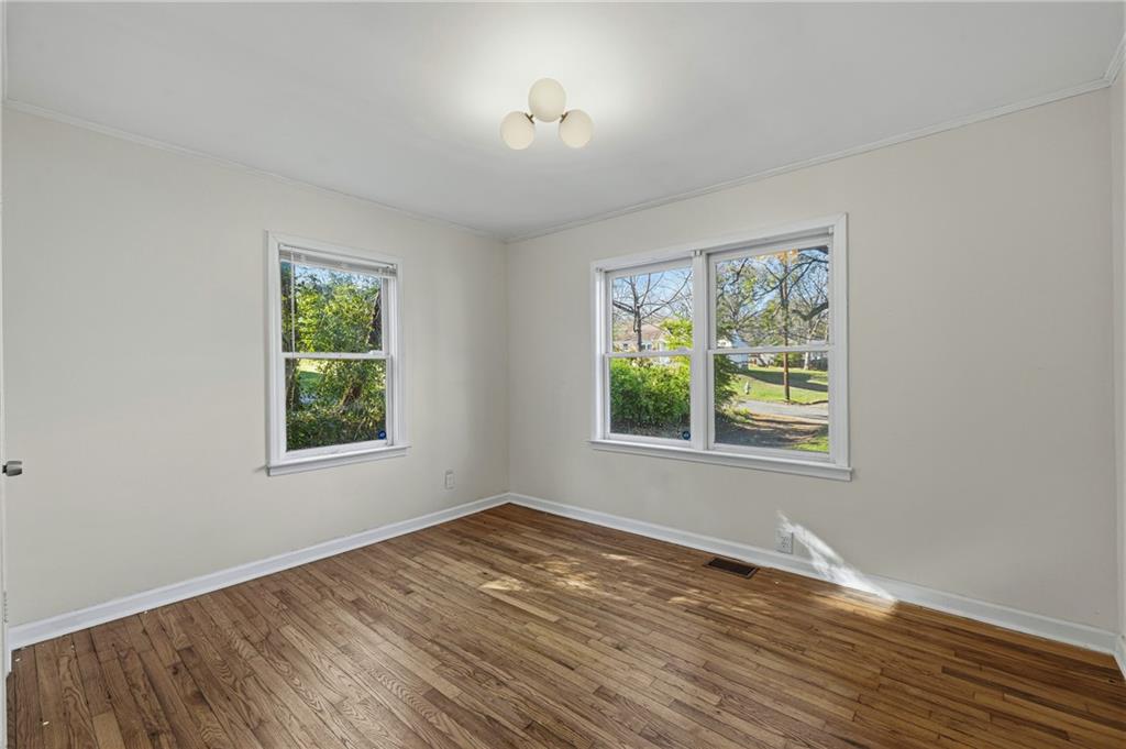 2583 Joyce Avenue Decatur, GA 30032 - Photo 17 of 30 an empty room with wooden floor and windows