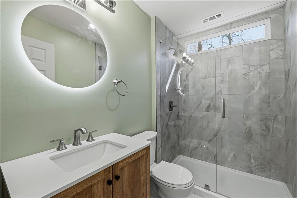 2583 Joyce Avenue Decatur, GA 30032 - Photo 19 of 30 a bathroom with a sink a toilet and shower