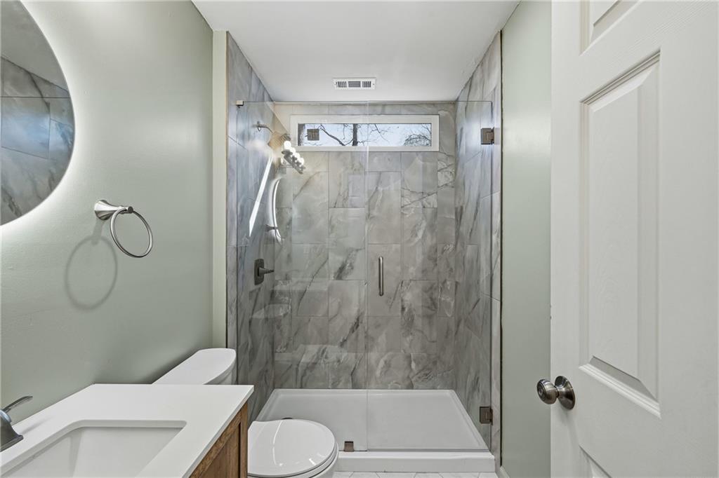 2583 Joyce Avenue Decatur, GA 30032 - Photo 20 of 30 a bathroom with a toilet and shower