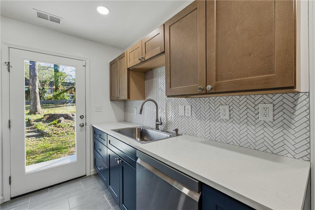 2583 Joyce Avenue Decatur, GA 30032 - Photo 5 of 30 a view of a sink and dishwasher with wooden floor