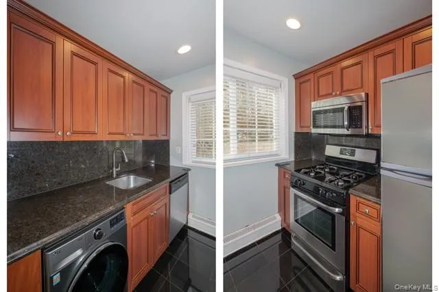 a kitchen with granite countertop a stove sink and microwave