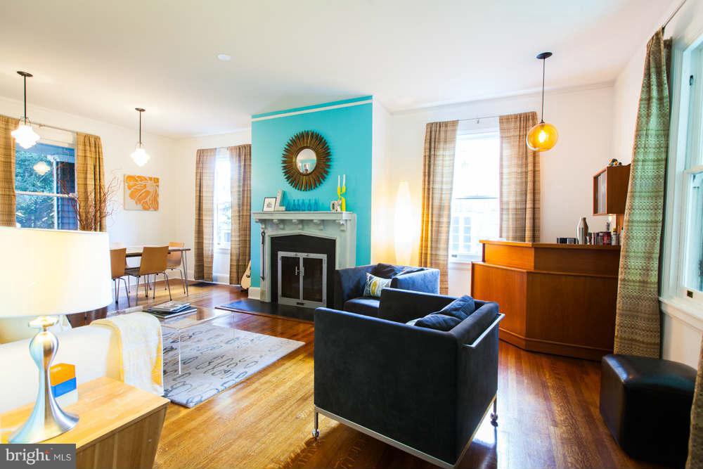 107 Longwood Road Baltimore, MD 21210 - Photo 3 of 30 Sunny Living/Dining Room w/Wood-burning Fireplace