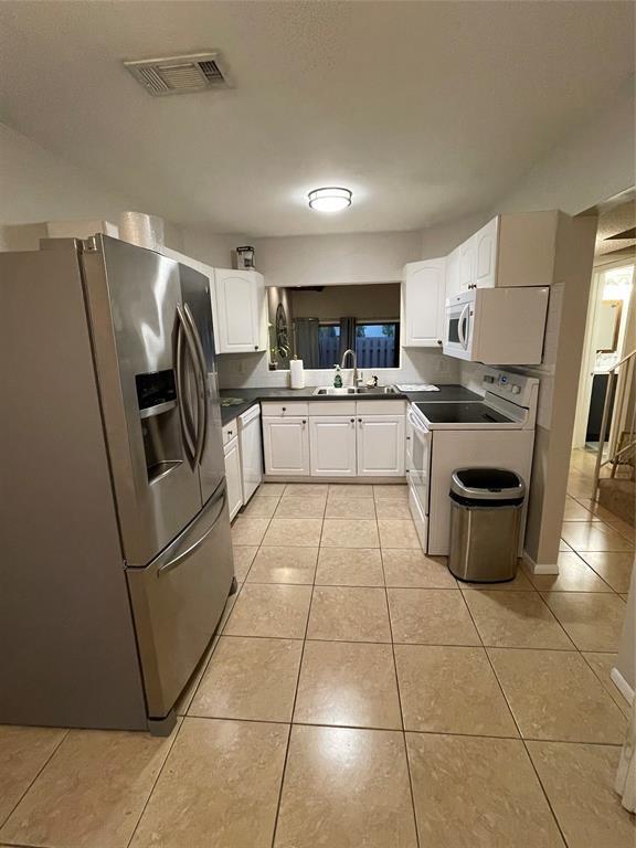 2156 Southwest 82nd Avenue, Unit 2156 Davie, FL 33324 - Photo 13 of 24 a kitchen with stainless steel appliances granite countertop a refrigerator and a stove top oven