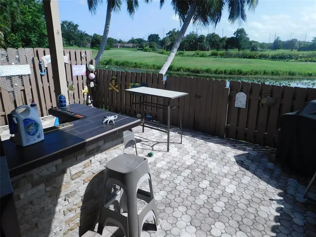 a view of a chairs and table in the patio