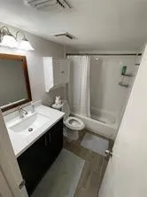 a bathroom with a sink toilet and shower