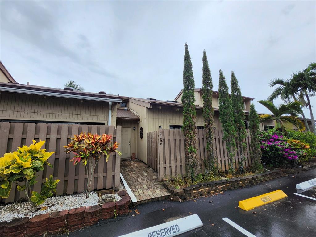 2156 Southwest 82nd Avenue, Unit 2156 Davie, FL 33324 - Photo 2 of 24 a front view of a house with yard