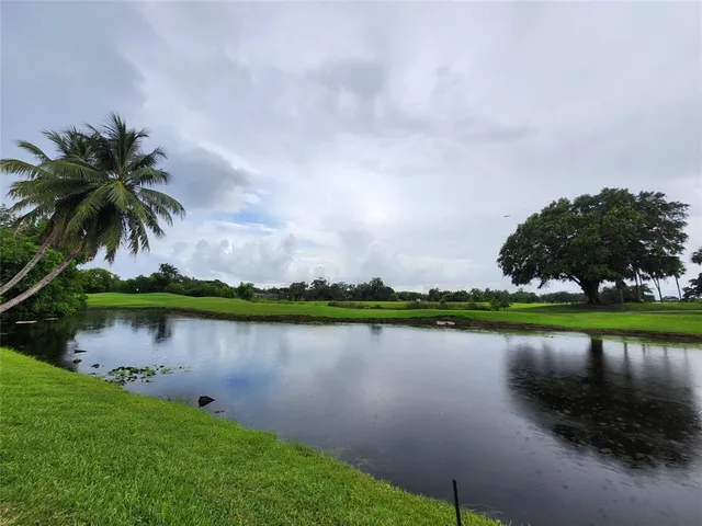 an aerial view of a house with outdoor space and lake view