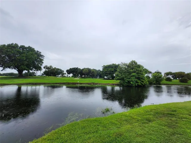 an aerial view of a house with a garden and lake view