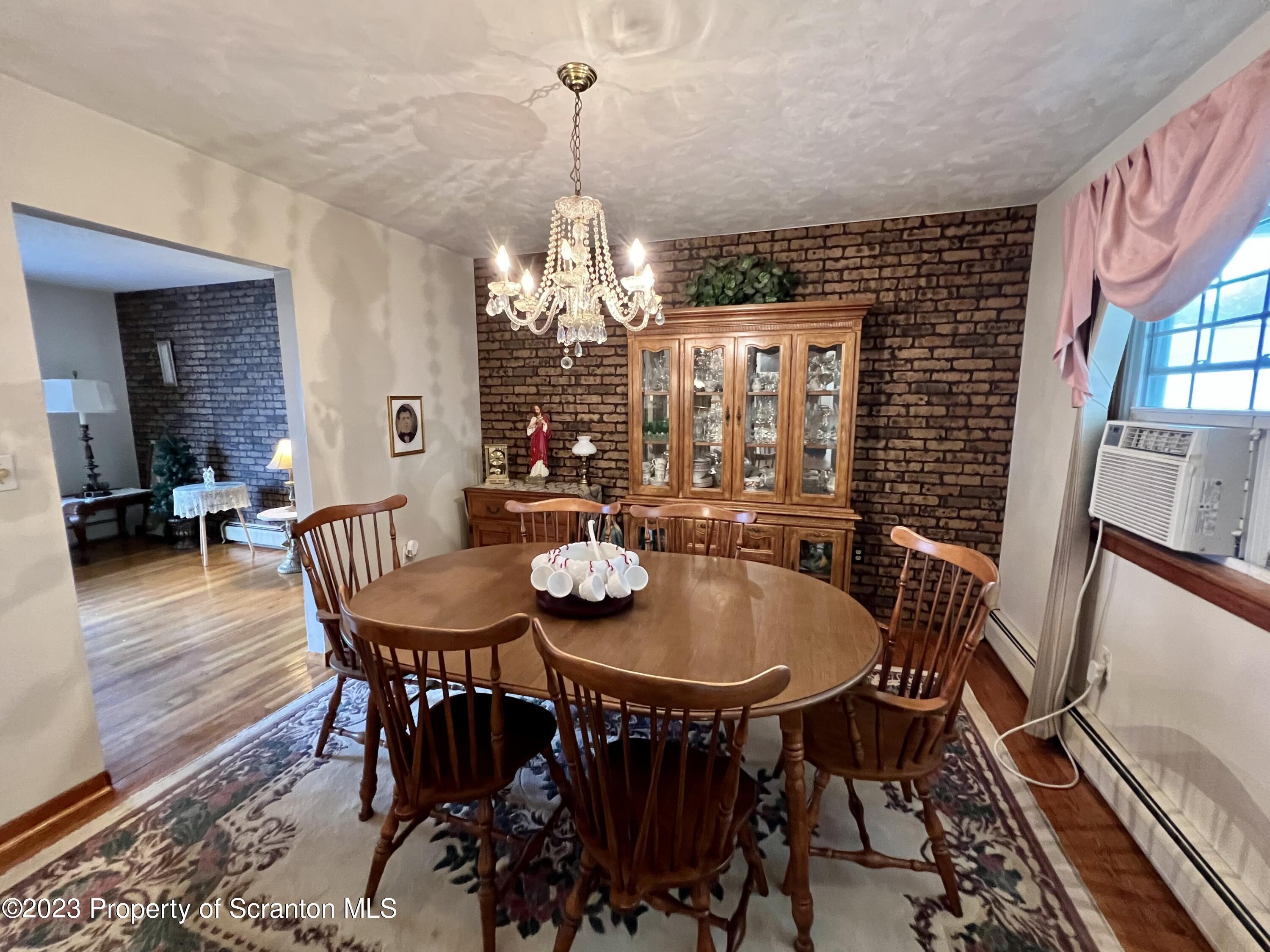 218 Jackson Street Olyphant, PA 18447 - Photo 11 of 46 a view of a dining room with furniture wooden floor and chandelier