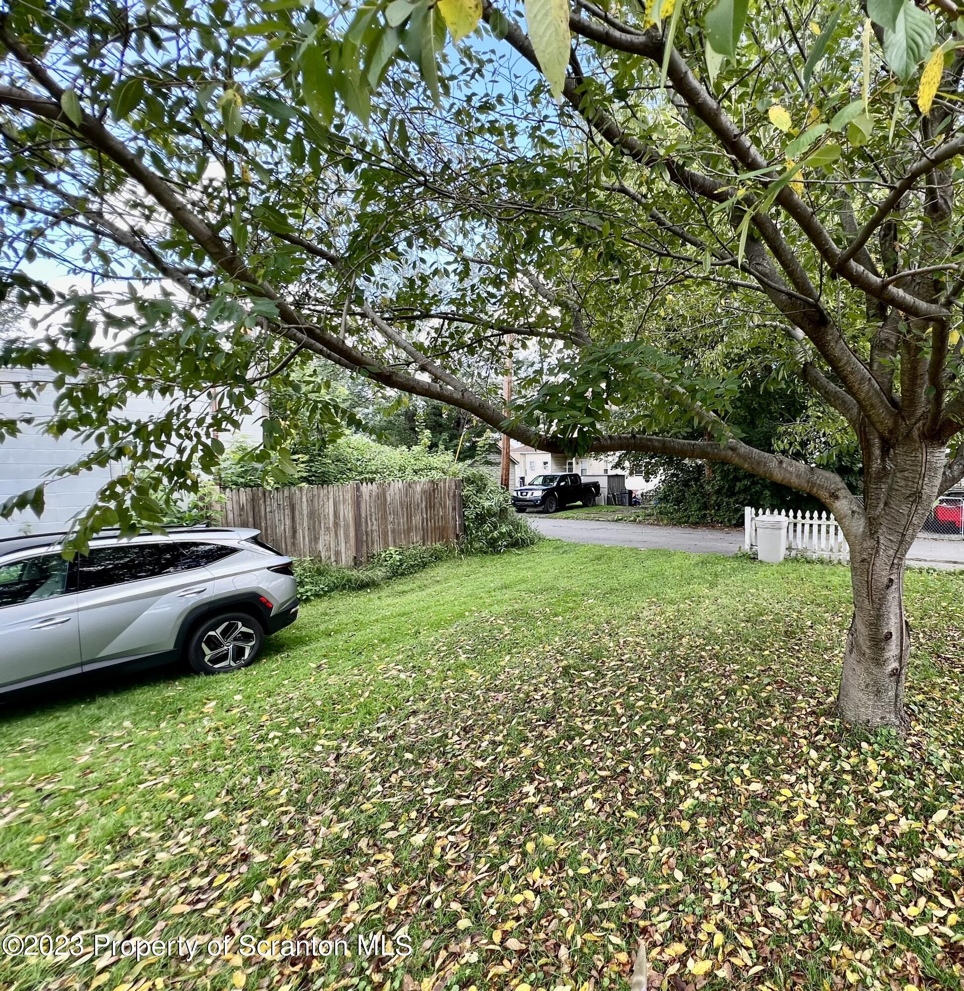 218 Jackson Street Olyphant, PA 18447 - Photo 17 of 46 a view of a yard with a car parked