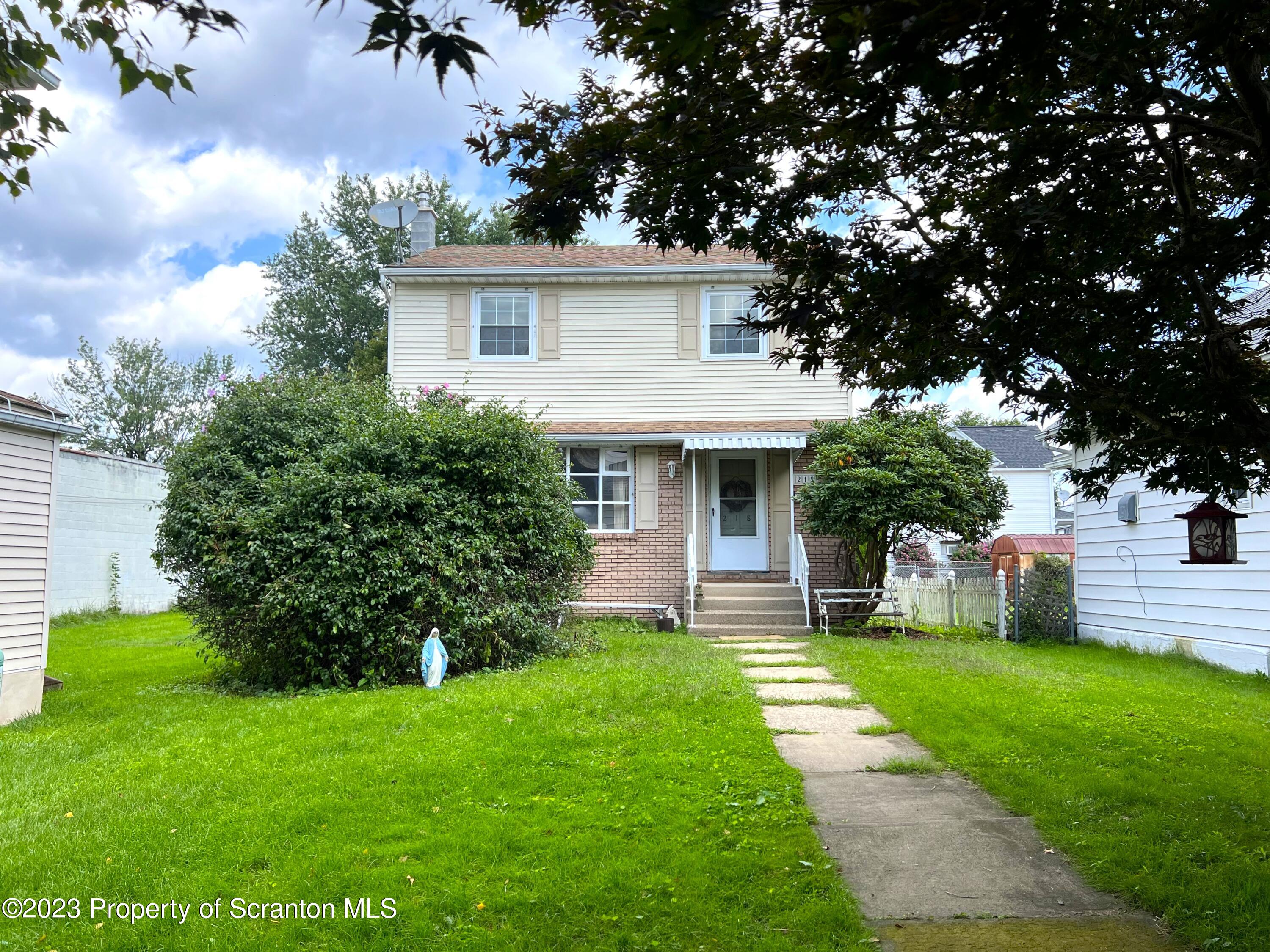 218 Jackson Street Olyphant, PA 18447 - Photo 2 of 46 a front view of house with yard and green space
