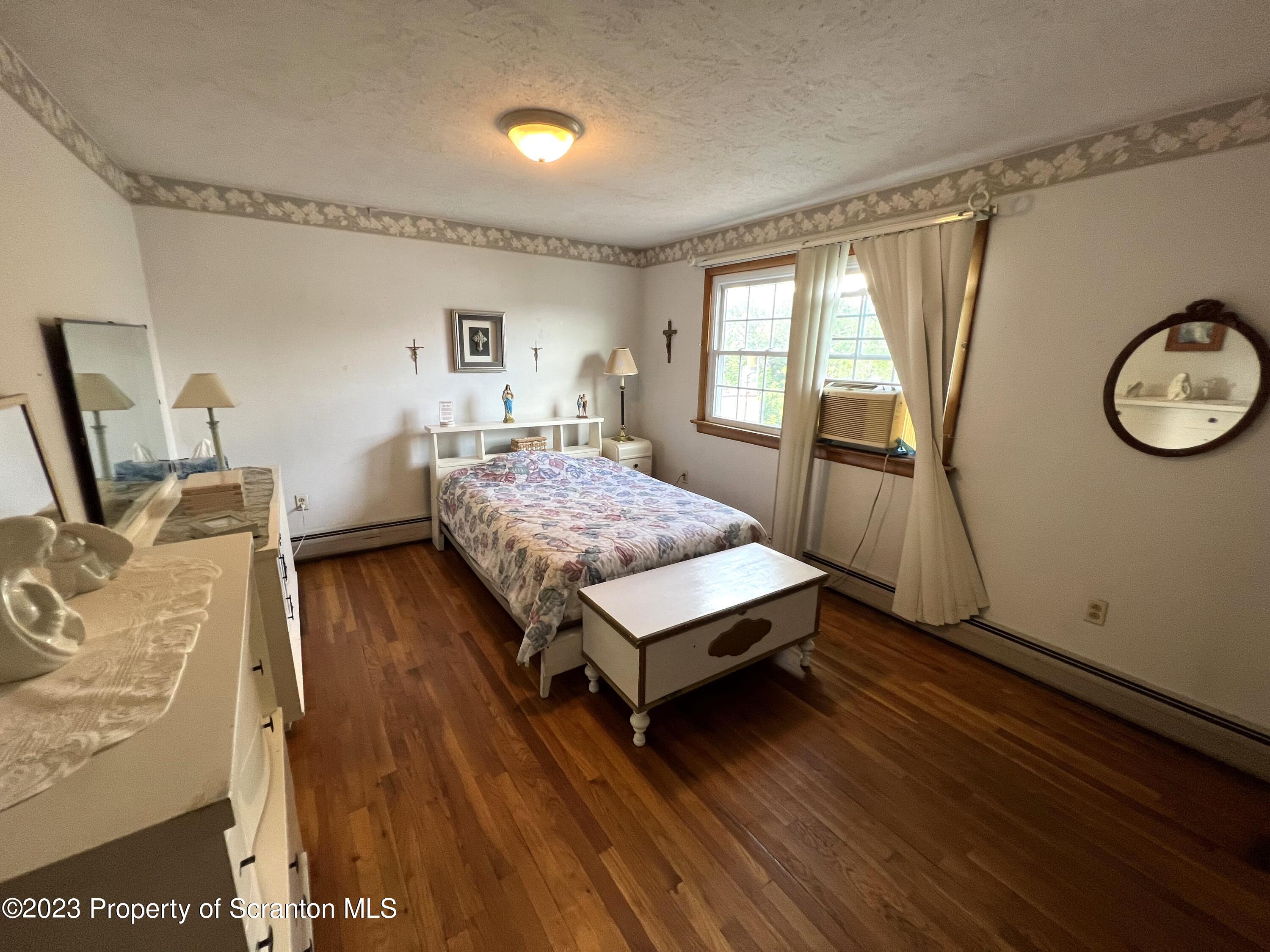 218 Jackson Street Olyphant, PA 18447 - Photo 24 of 46 a living room with a bed furniture and a large window