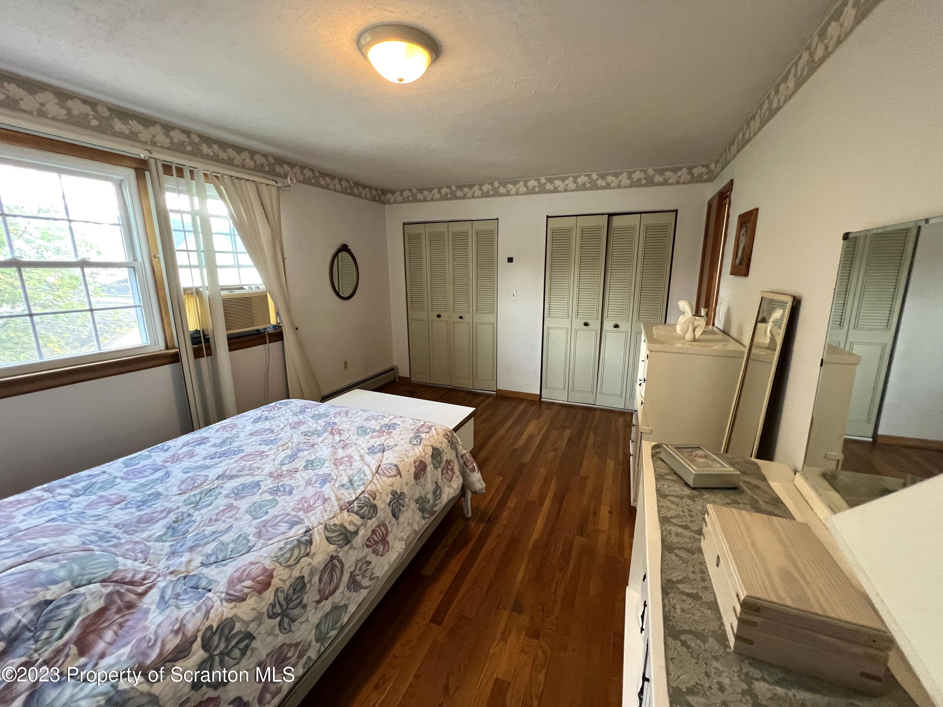 218 Jackson Street Olyphant, PA 18447 - Photo 26 of 46 a bedroom with a bed and wooden floor