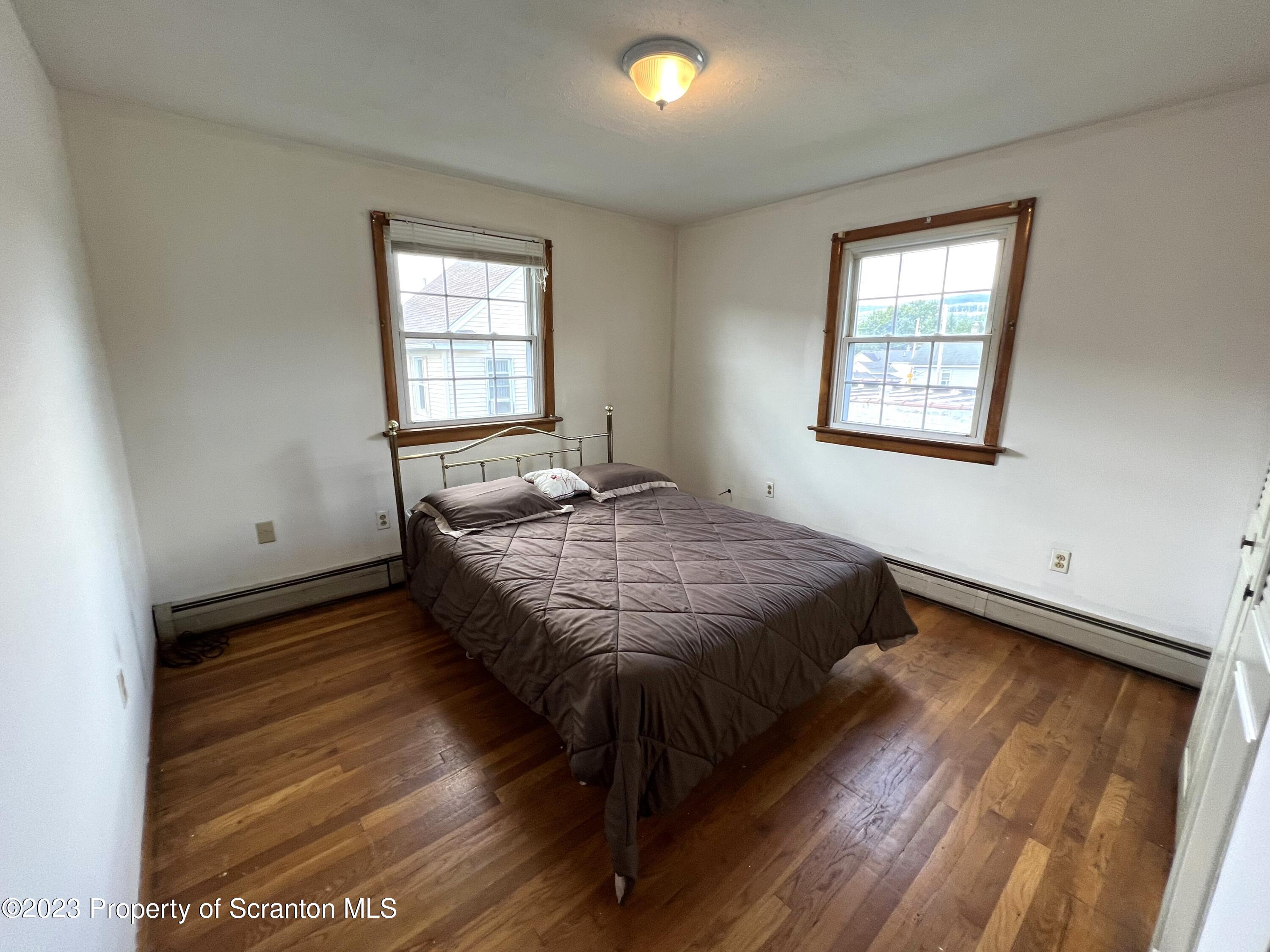 218 Jackson Street Olyphant, PA 18447 - Photo 27 of 46 a bed sitting in a bedroom next to a window