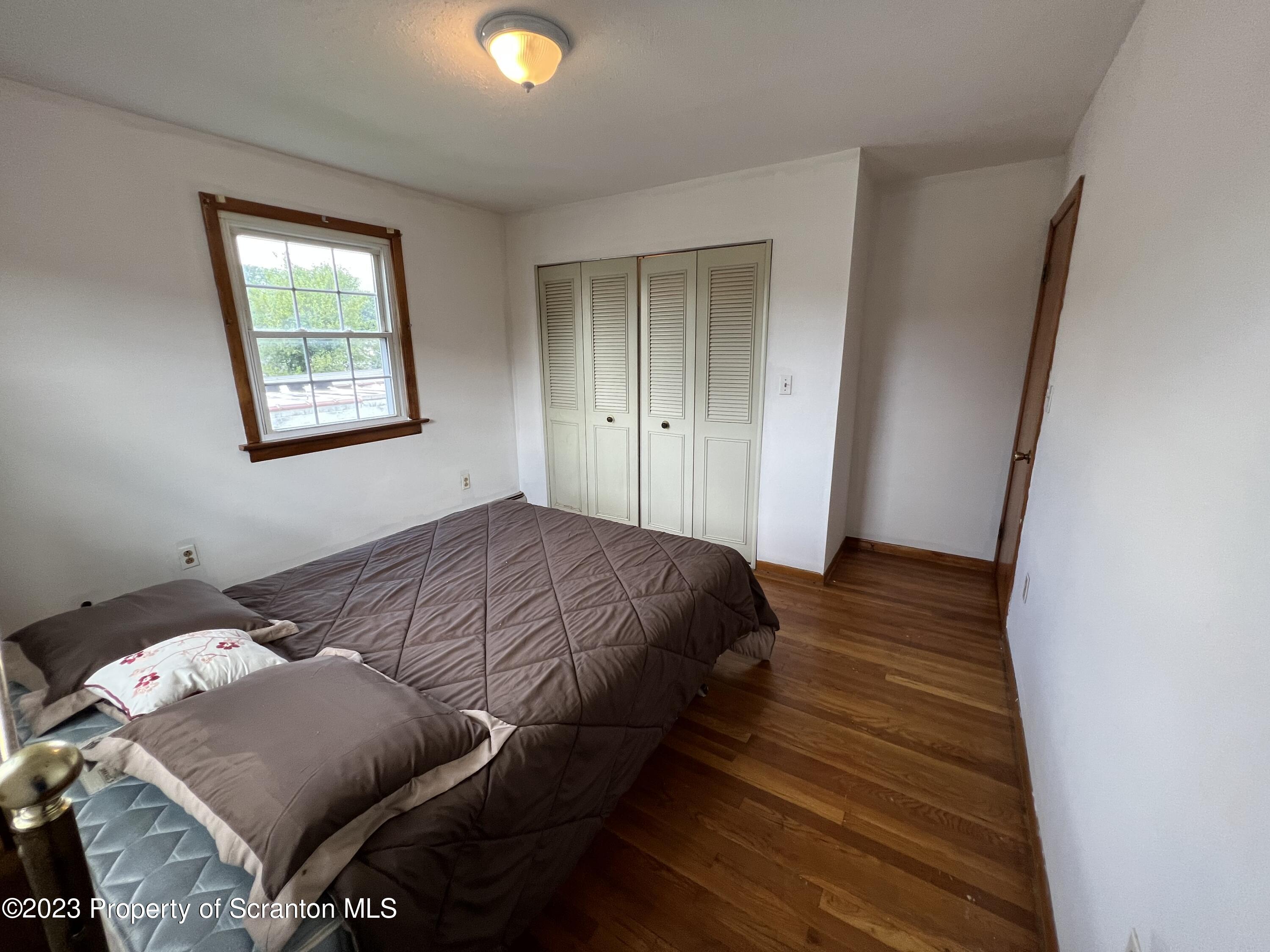 218 Jackson Street Olyphant, PA 18447 - Photo 28 of 46 a bedroom with a bed and window