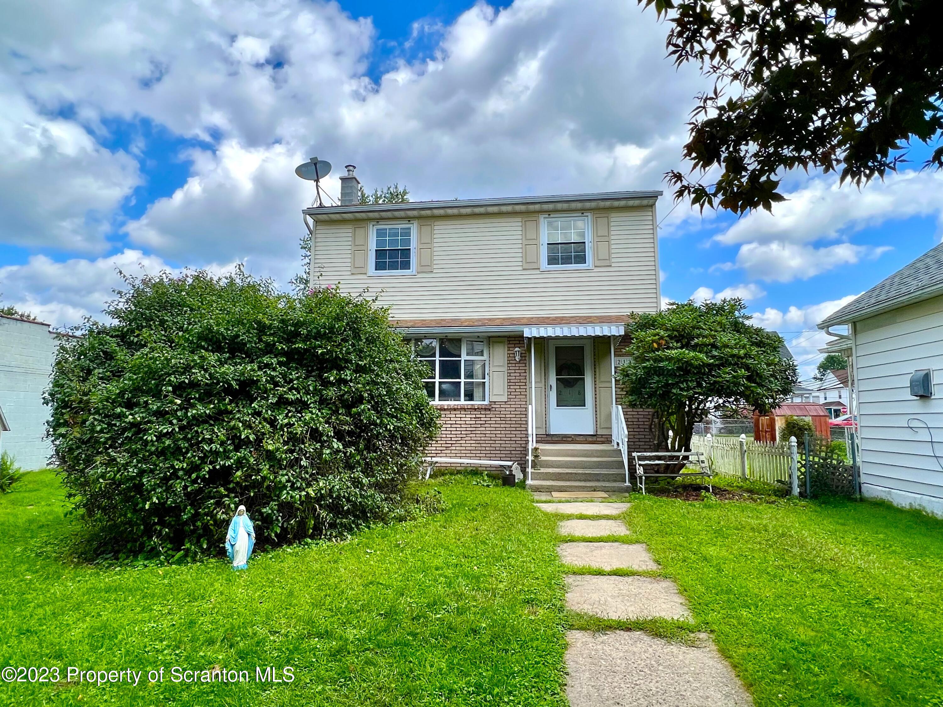 218 Jackson Street Olyphant, PA 18447 - Photo 45 of 46 a front view of a house with garden