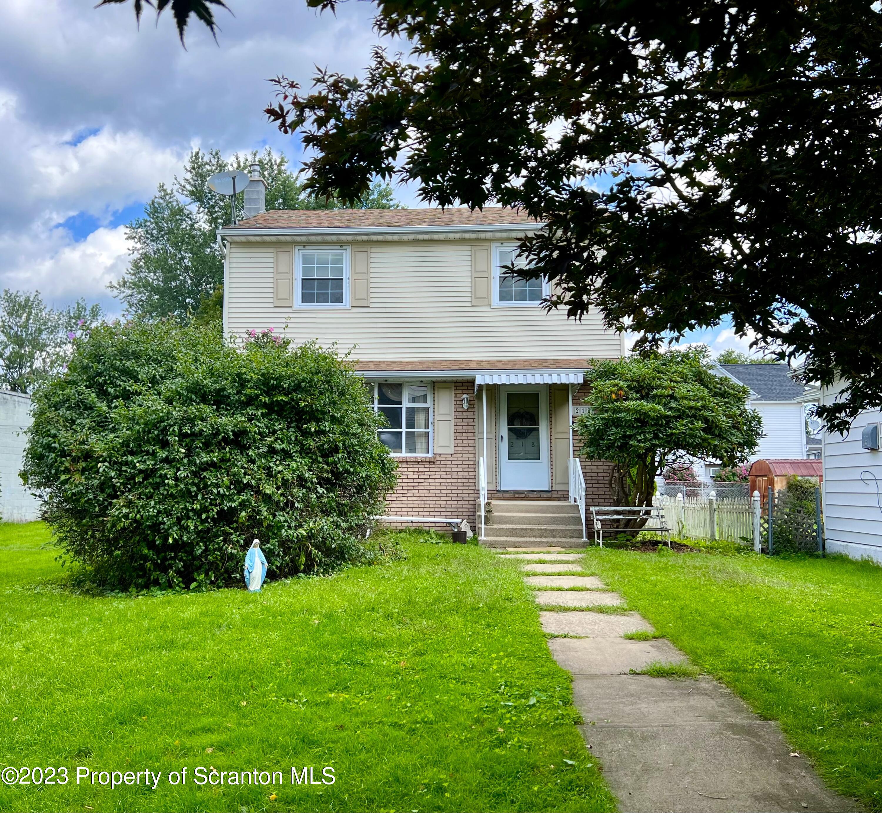 218 Jackson Street Olyphant, PA 18447 - Photo 46 of 46 a front view of house with a garden