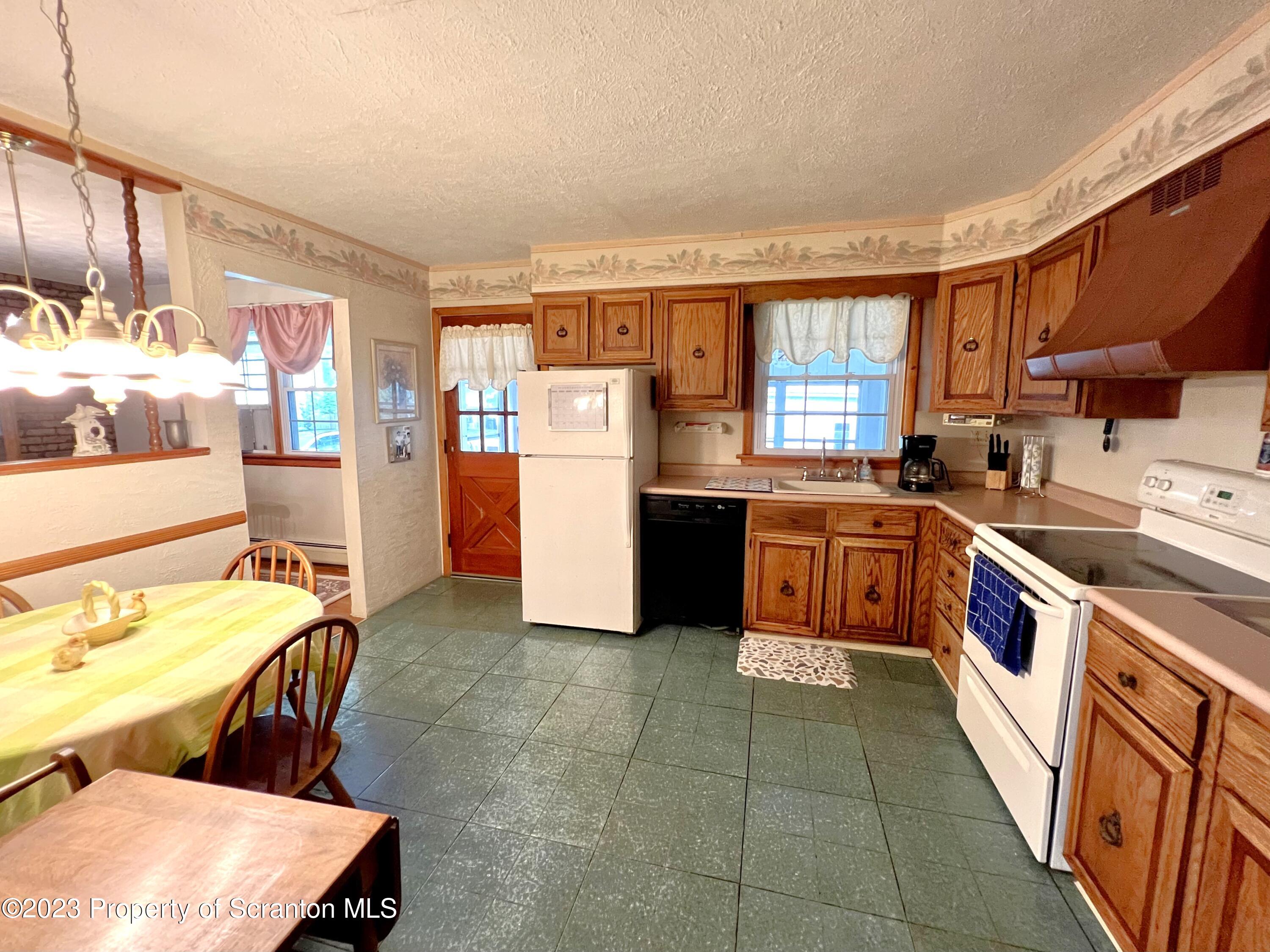 218 Jackson Street Olyphant, PA 18447 - Photo 6 of 46 a kitchen with a stove a sink and a refrigerator
