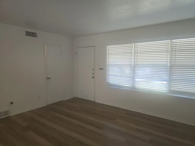 wooden floor in an empty room with a window