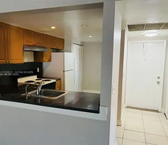 a kitchen with stainless steel appliances a refrigerator and a stove