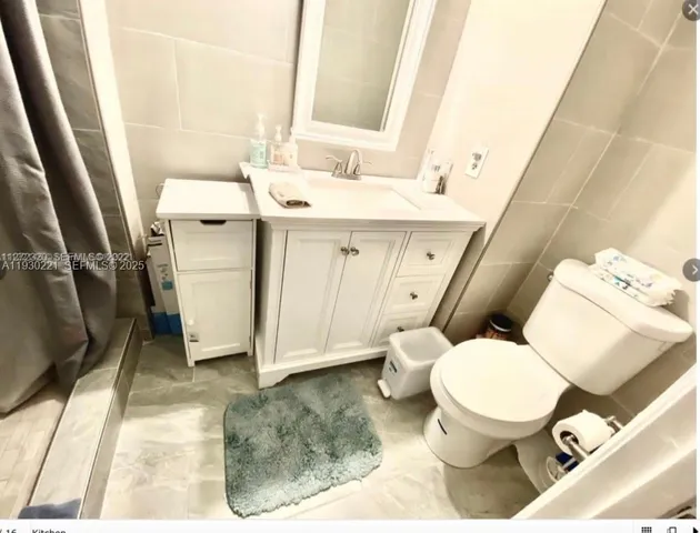 a white toilet sitting next to a bathroom sink