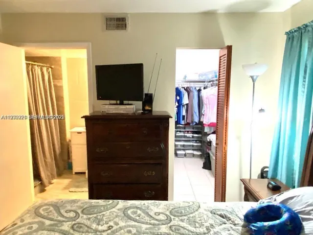 a bedroom with a bed and television