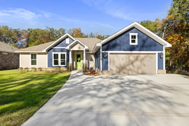 a front view of a house with a garden and patio