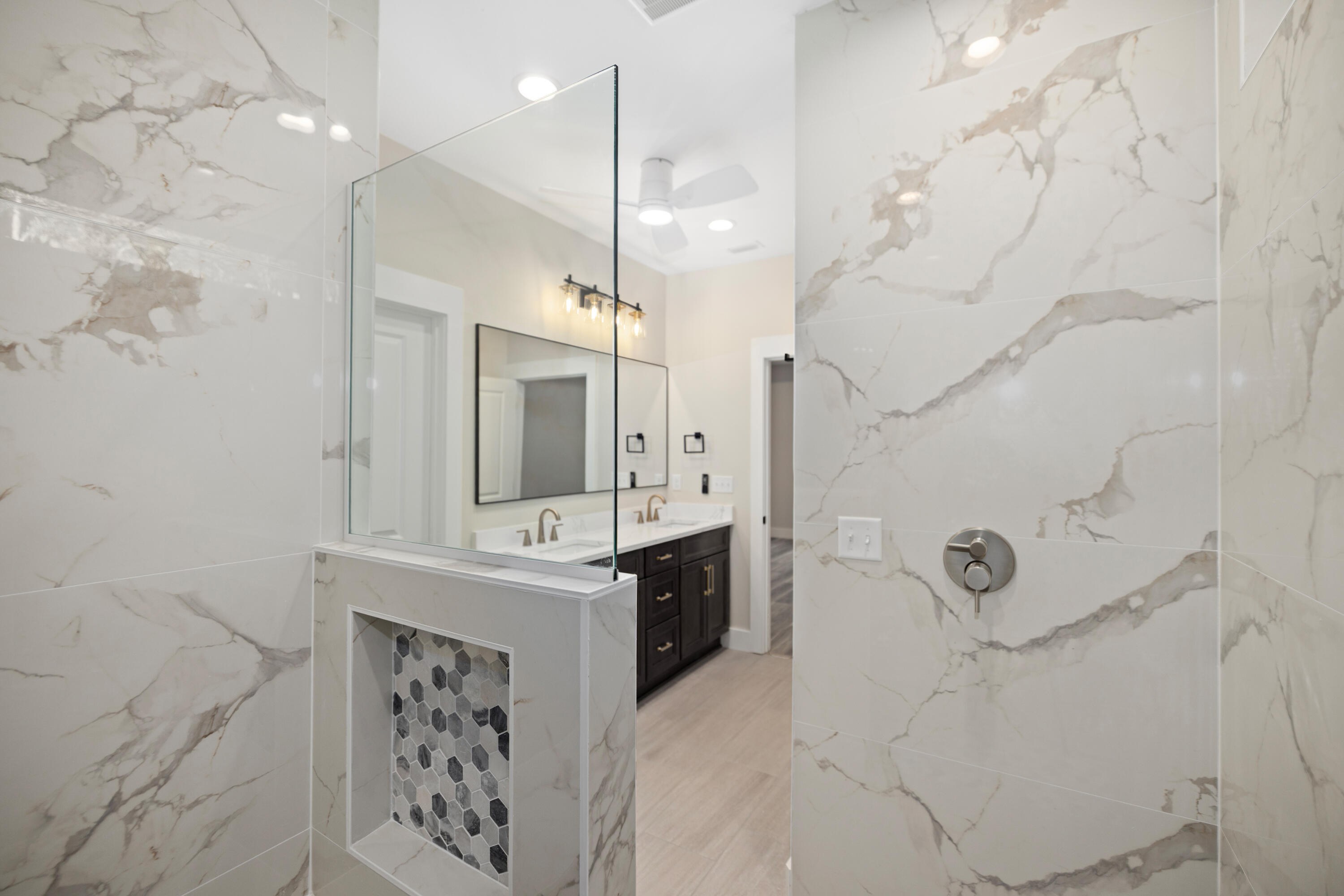 119 Spruce Street Freeport, FL 32439 - Photo 11 of 28 a spacious bathroom with a sink a mirror a vanity and shower