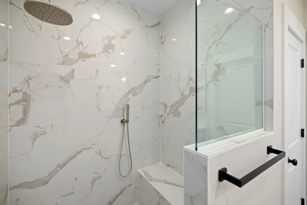 a spacious bathroom with a sink a mirror a vanity and shower