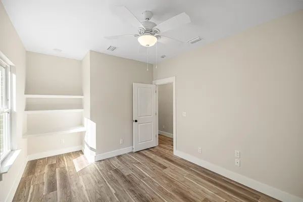 a view of walk in closet with empty racks