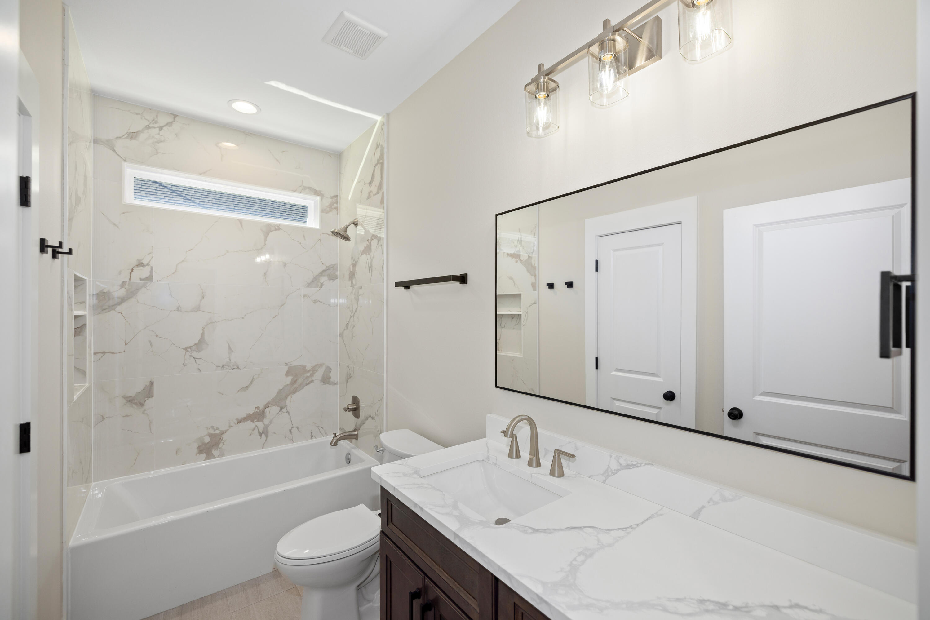 119 Spruce Street Freeport, FL 32439 - Photo 19 of 28 a bathroom with a bathtub shower sink vanity and toilet