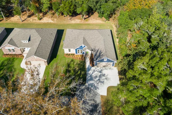 an aerial view of a house with a yard
