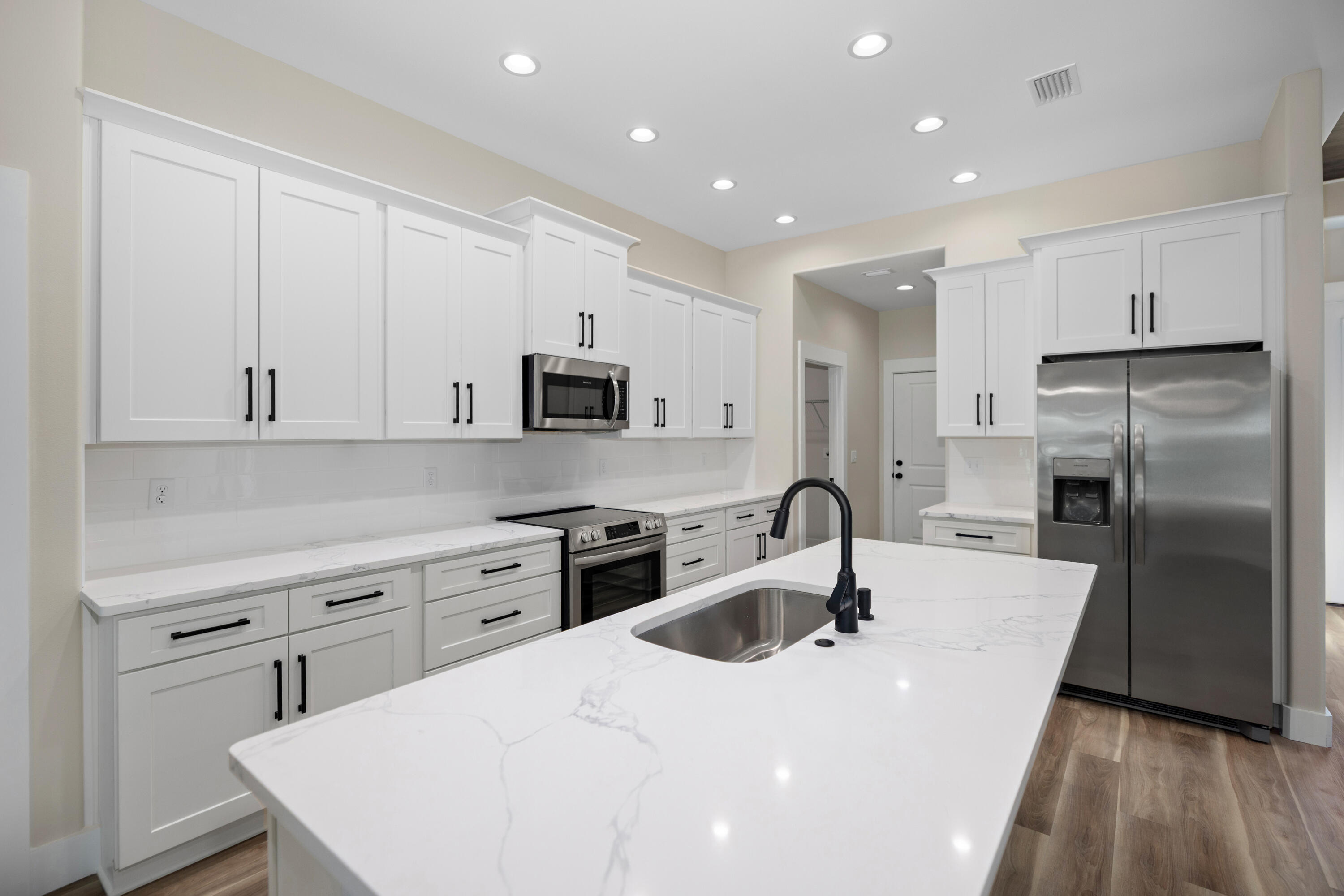 119 Spruce Street Freeport, FL 32439 - Photo 4 of 28 a kitchen with stainless steel appliances a sink stove and refrigerator