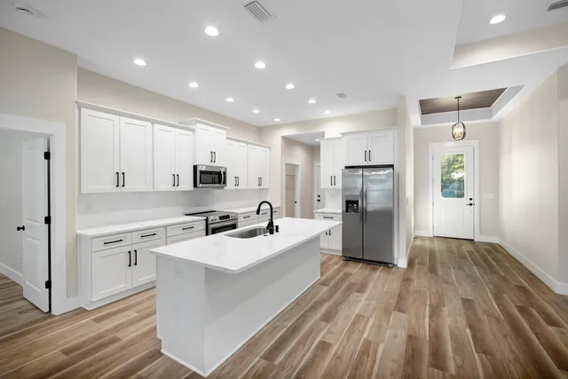 a kitchen with stainless steel appliances a sink stove and refrigerator
