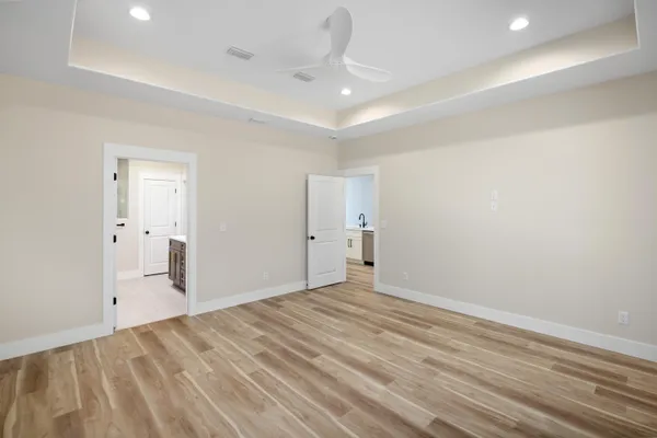 en empty room with wooden floor and windows
