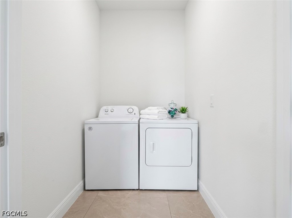 8753 Buckingham Road Lehigh Acres, FL 33971 - Photo 12 of 13 a utility room with dryer and washer