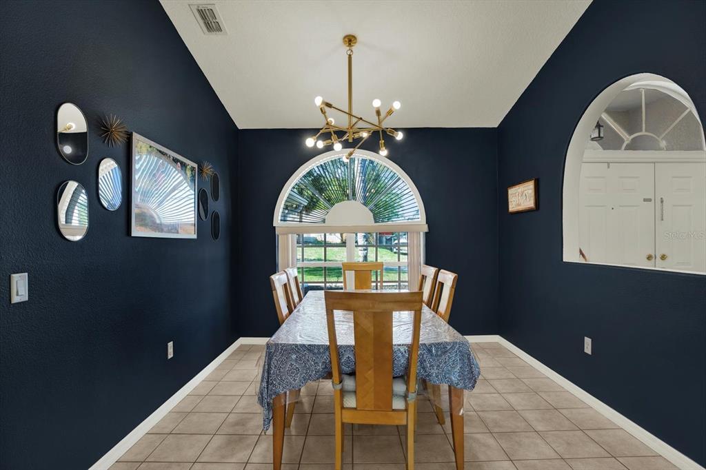 5220 Kirkwood Avenue Spring Hill, FL 34608 - Photo 11 of 39 a view of a dining room with a table and chairs