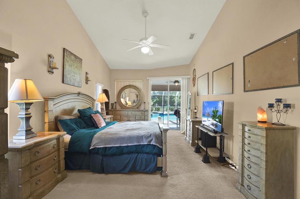 5220 Kirkwood Avenue Spring Hill, FL 34608 - Photo 13 of 39 a bedroom with a bed wooden floor and window