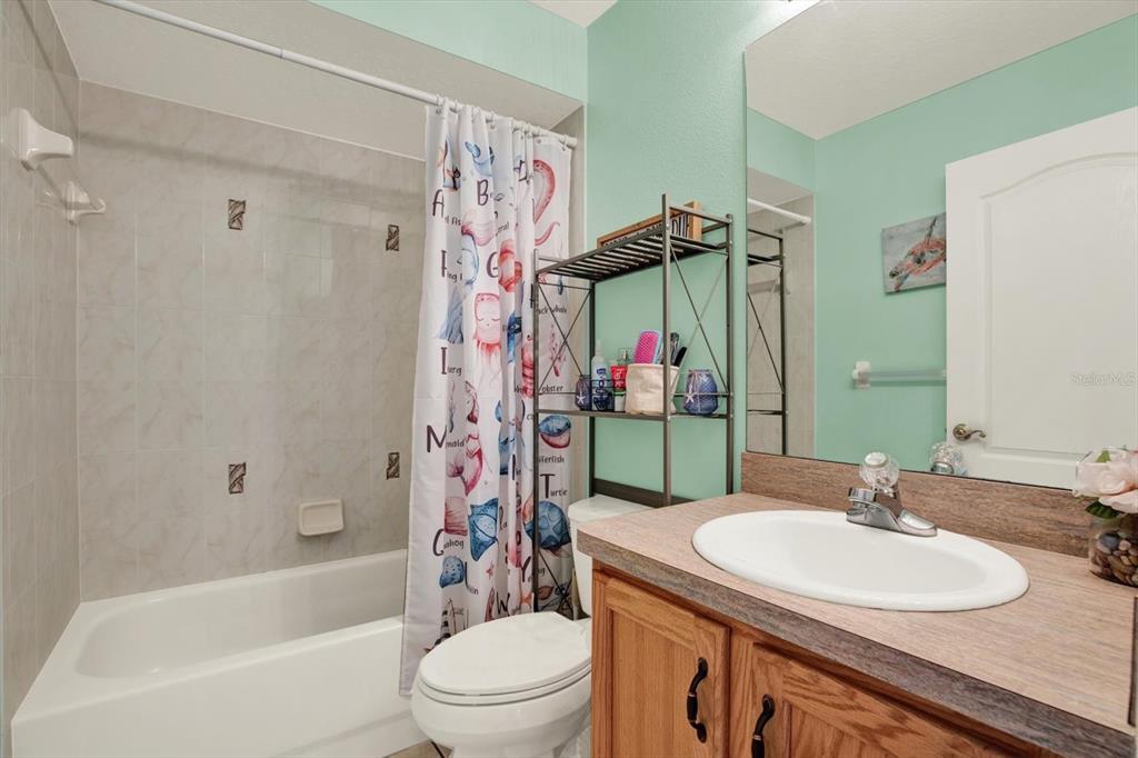 5220 Kirkwood Avenue Spring Hill, FL 34608 - Photo 20 of 39 a bathroom with a sink toilet and shower