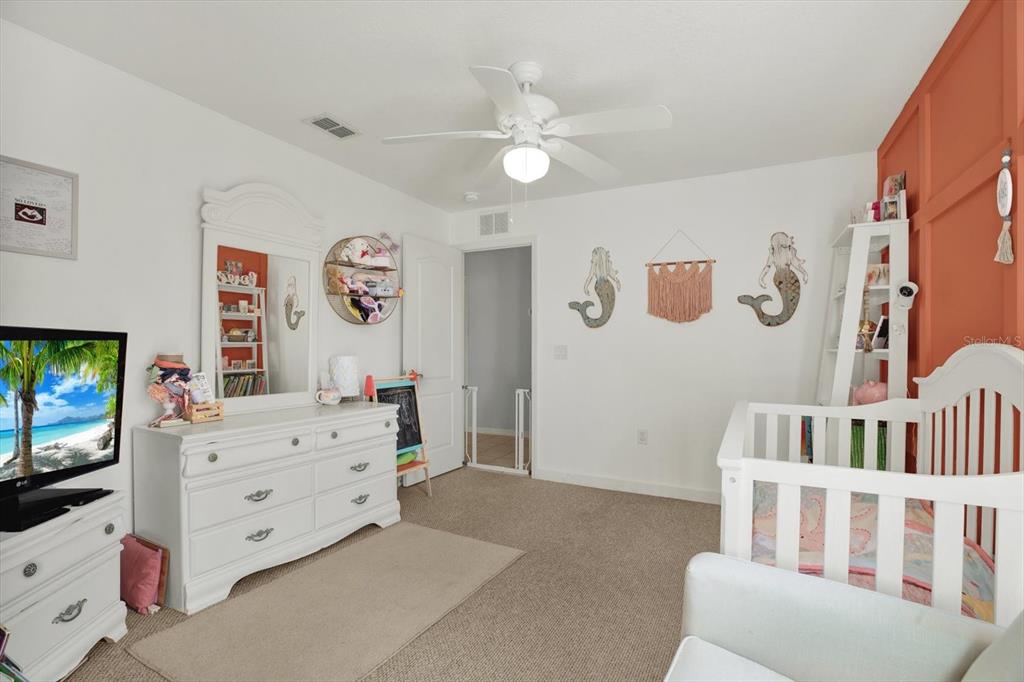 5220 Kirkwood Avenue Spring Hill, FL 34608 - Photo 21 of 39 a bedroom with furniture and a flat screen tv