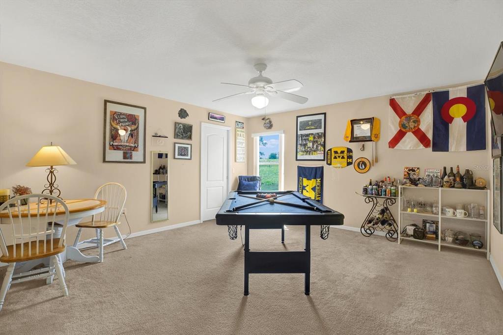 5220 Kirkwood Avenue Spring Hill, FL 34608 - Photo 22 of 39 a living room with furniture and paintings on the wall