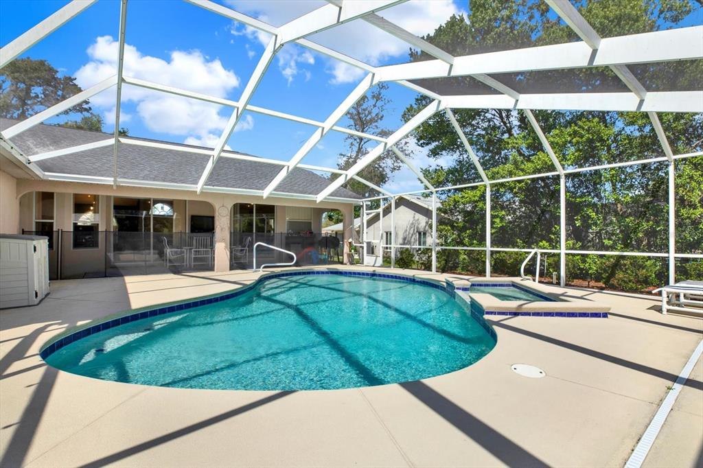 5220 Kirkwood Avenue Spring Hill, FL 34608 - Photo 26 of 39 a view of a swimming pool with a patio and a yard