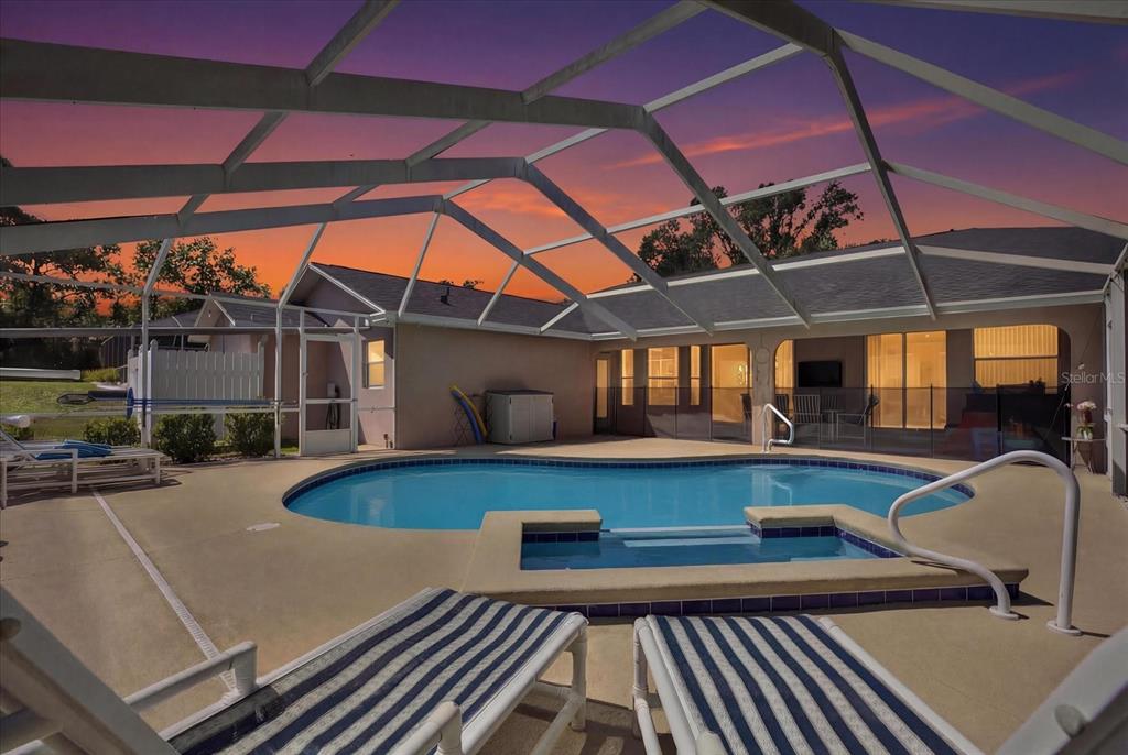 5220 Kirkwood Avenue Spring Hill, FL 34608 - Photo 27 of 39 a view of a patio with swimming pool table and chairs