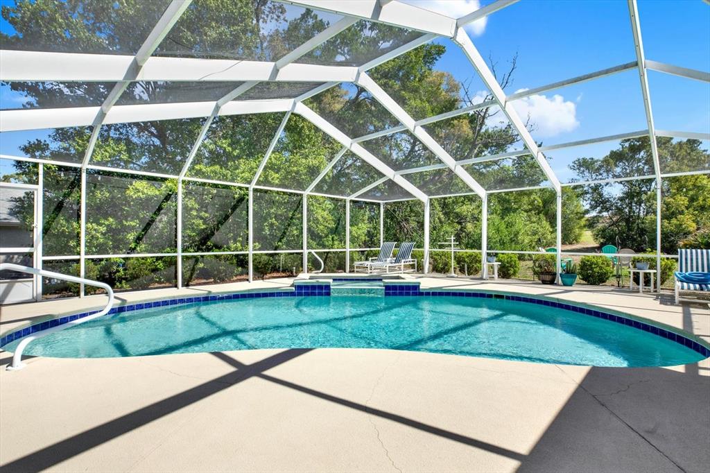 5220 Kirkwood Avenue Spring Hill, FL 34608 - Photo 29 of 39 a view of a backyard with a swimming pool
