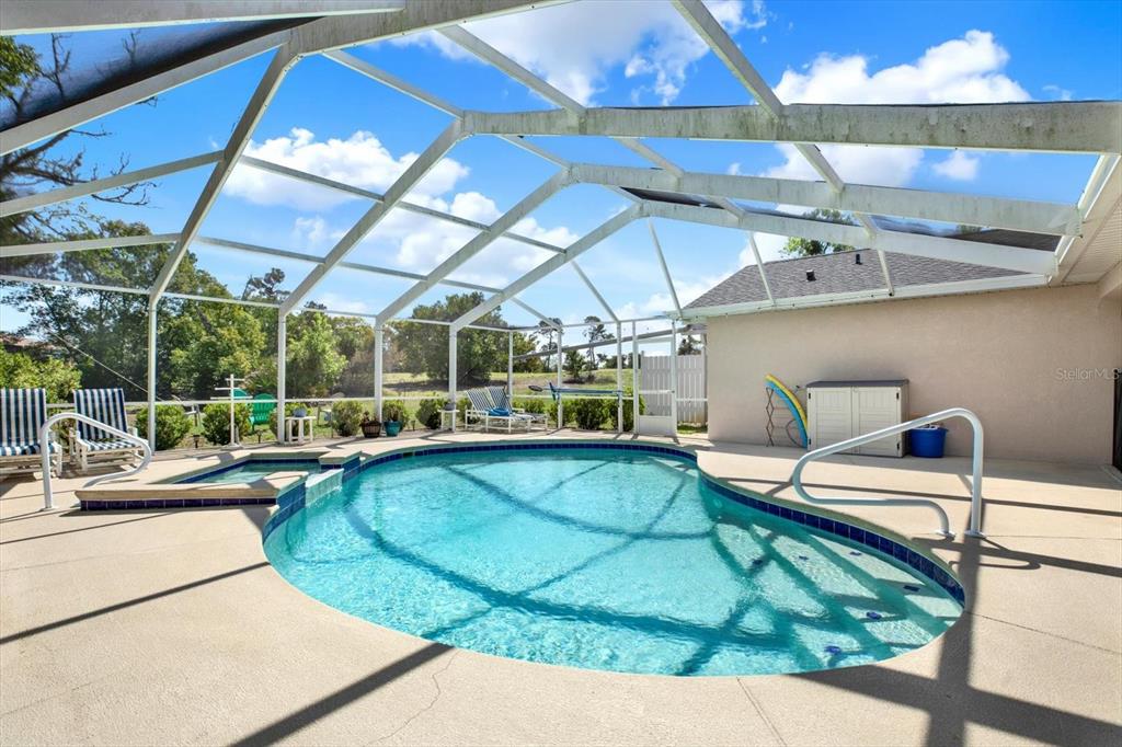 5220 Kirkwood Avenue Spring Hill, FL 34608 - Photo 30 of 39 a view of a swimming pool with a patio