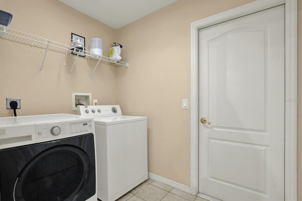 5220 Kirkwood Avenue Spring Hill, FL 34608 - Photo 31 of 39 a utility room with dryer and washer