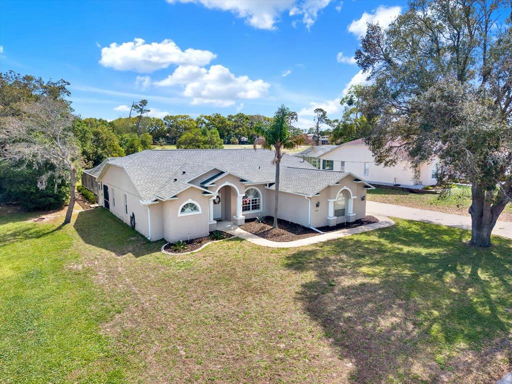 5220 Kirkwood Avenue Spring Hill, FL 34608 - Photo 33 of 39 an aerial view of a house with yard and large tree