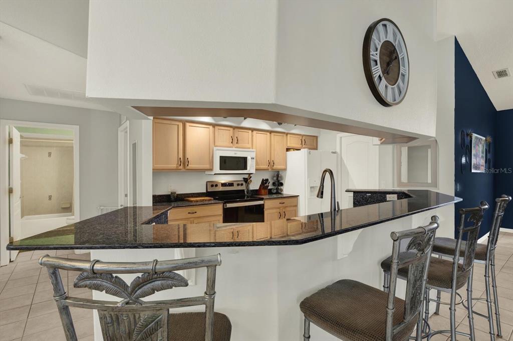 5220 Kirkwood Avenue Spring Hill, FL 34608 - Photo 5 of 39 a kitchen with dining table and chairs