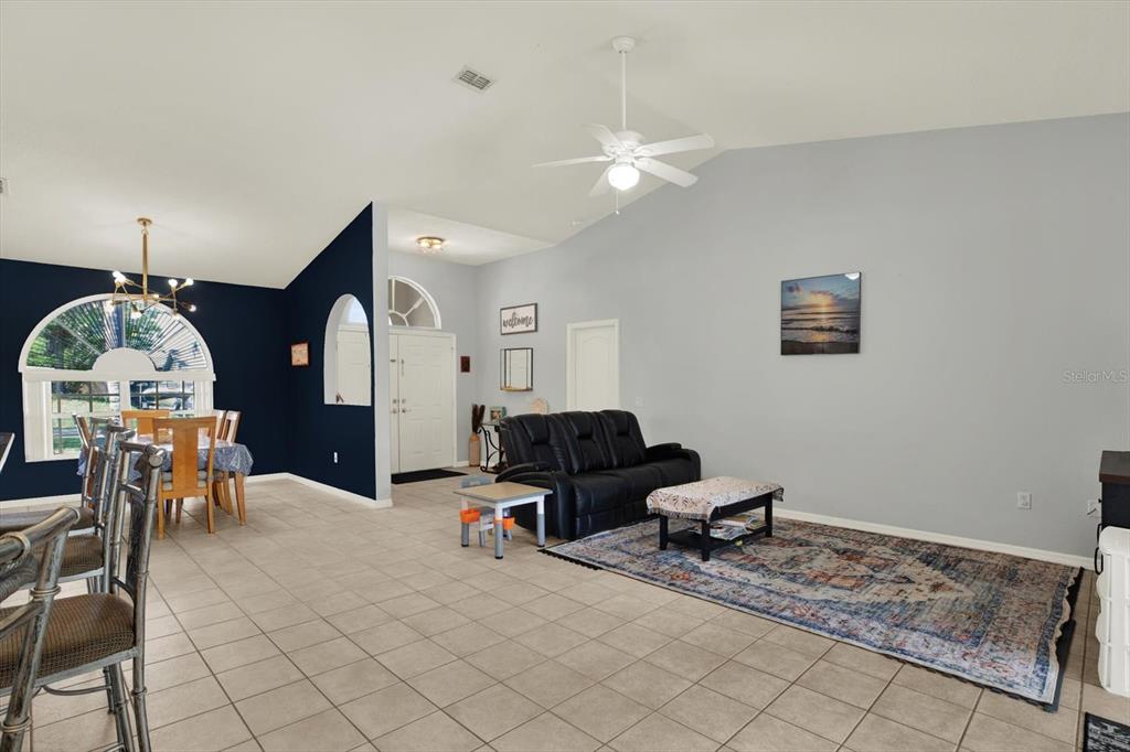 5220 Kirkwood Avenue Spring Hill, FL 34608 - Photo 8 of 39 a living room with furniture and a chandelier
