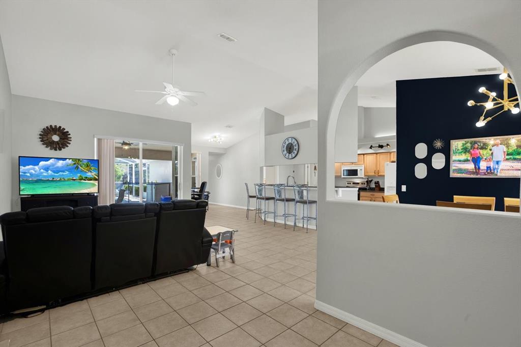 5220 Kirkwood Avenue Spring Hill, FL 34608 - Photo 9 of 39 a living room with furniture and a flat screen tv